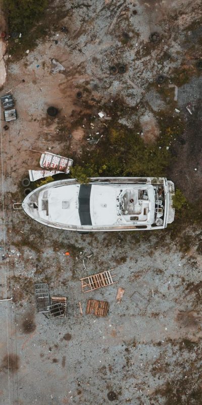 Abandoned yacht and truck junked in countryside