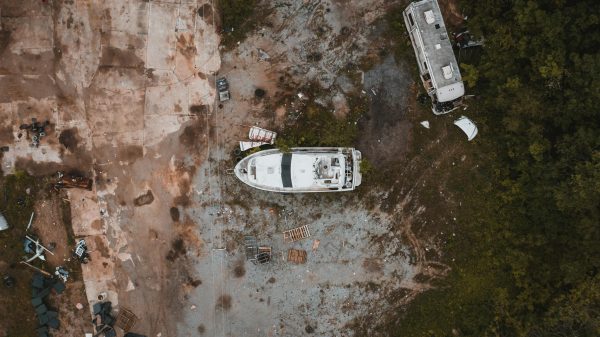 Abandoned yacht and truck junked in countryside