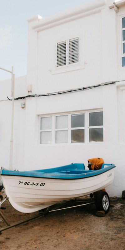 Small Boat by White Coastal House